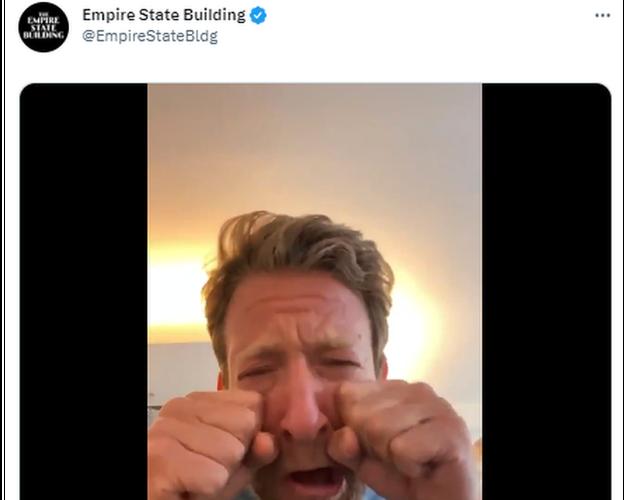 Empire state Building responding to a troll tweet with a video of someone sarcastically crying