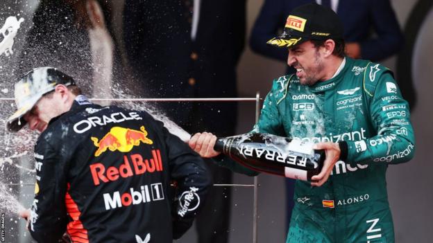 Fernando Alonso sprays champagne over Max Verstappen on the podium in Monaco