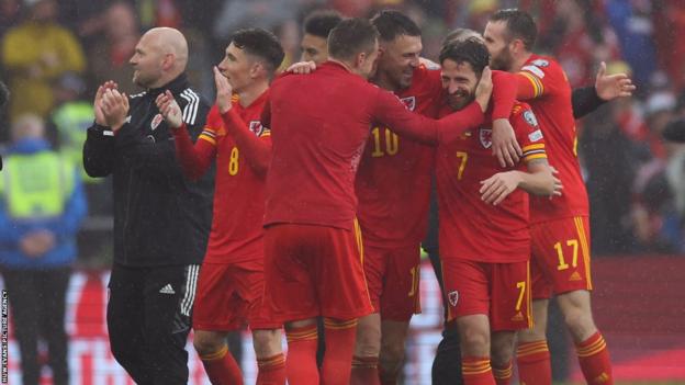 Joe Allen reacts to Wales qualifying for World Cup with his team-mates