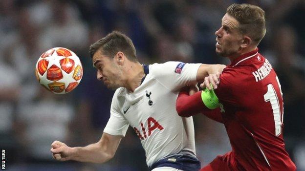 Tottenham's Harry Winks is challenged by Liverpool's Jordan Henderson