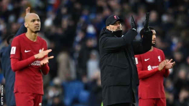 Liverpool players and manager applaud the fans after the FA Cup defeat at Brighton