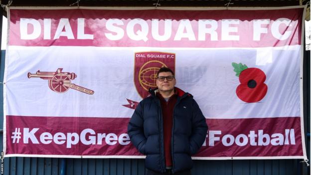 Dial Square fan Dave Nathan in front of a banner