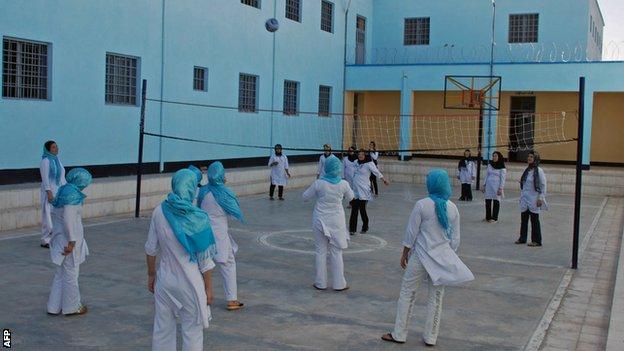 Female Afghan prisoners play volleyball at a prison in the eastern Afghan city of Herat on July 2, 2010
