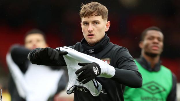 David Brooks warms up for Bournemouth before their game against Liverpool