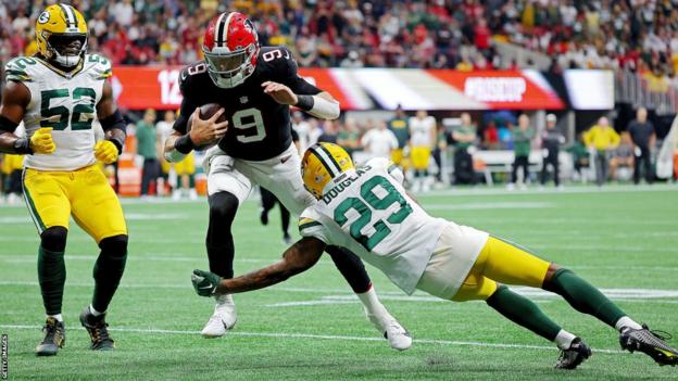 Falcons quarterback Desmond Ridder runs in a touchdown