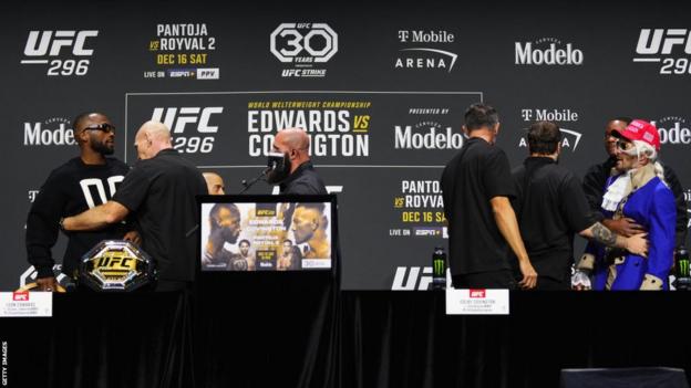 Leon Edwards and Colby Covington are separated by security at the UFC 296 news conference