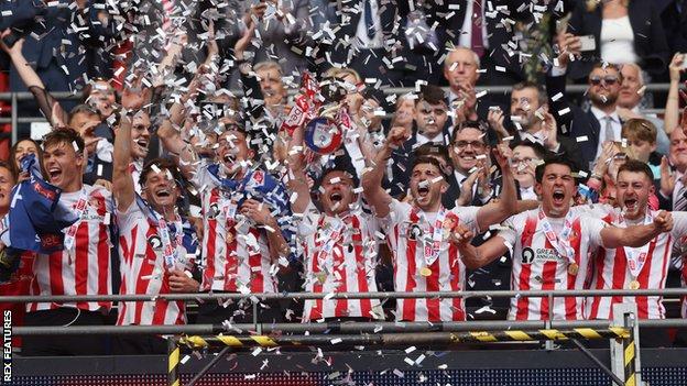 Sunderland players celebrate with the trophy