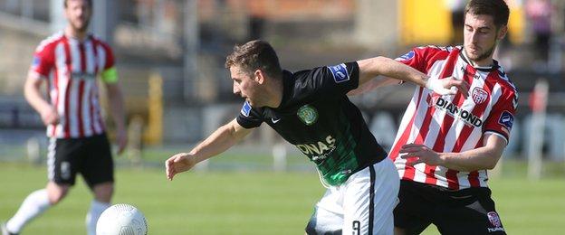 Bray striker Dean Kelly is challenged by Aaron Barry in the Brandywell sunshine