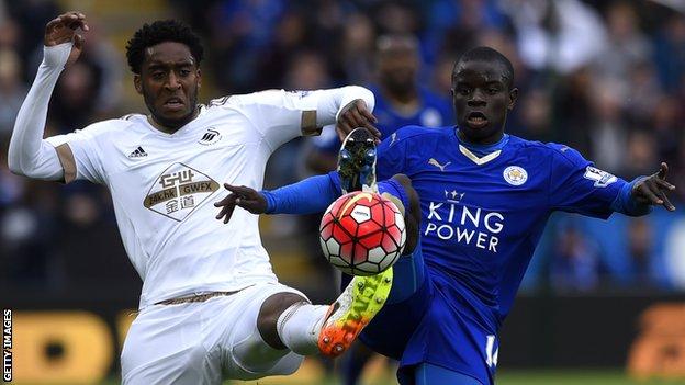 Leroy Fer of Swansea City and N'Golo Kante of Leicester City stretch for the ball during a Premier League match