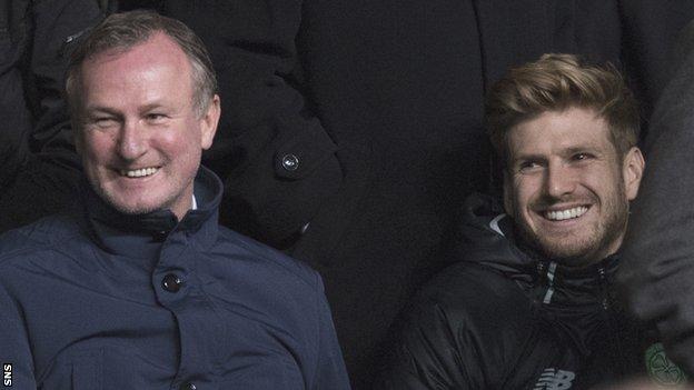 Michael O'Neill watches a Celtic match alongside Stuart Armstrong