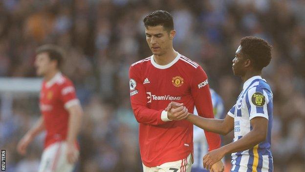 Manchester United's Cristiano Ronaldo shakes hands with Brighton & Hove Albion's Tariq Lamptey
