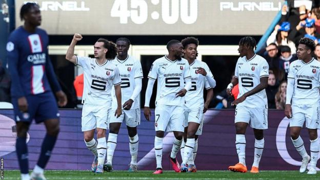 Rennes' Cameroonian forward Karl Toko Ekambi (centre) celebrates scoring his team's first goal during the French L1 football match between PSG and Rennes at the Parc des Princes stadium in Paris