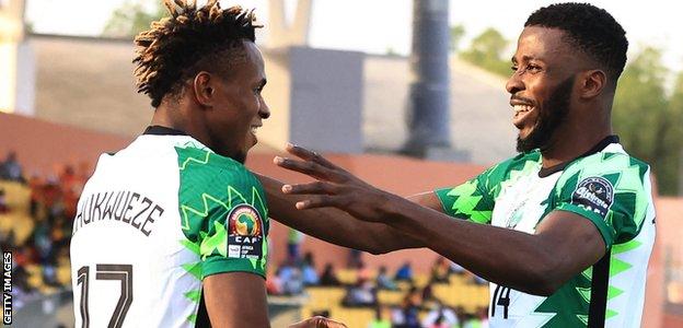 Samuel Chukwueze and Kelechi Iheanacho celebrate a goal for Nigeria