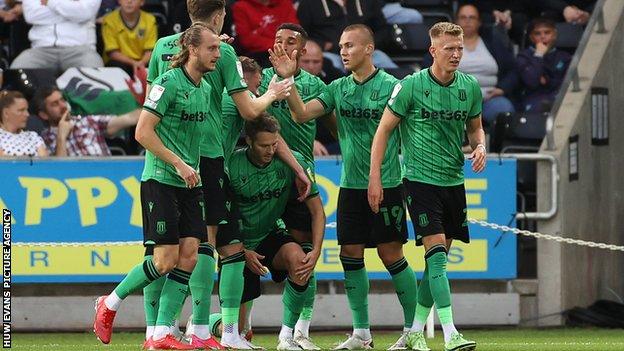 Stoke players celebrate after going in front through Nick Powell's second goal of the season