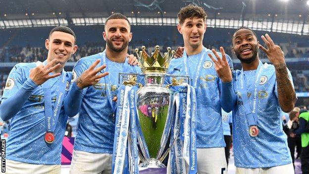 Phil Foden, Kyle Walker, John Stones and Raheem Sterling with the Premier League trophy