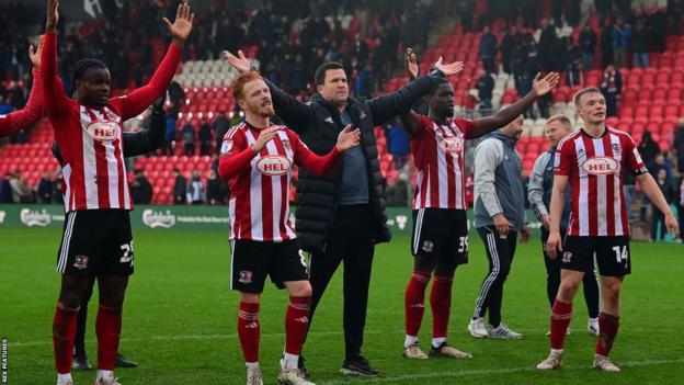 Exeter City platers celebrate Burton Albion win