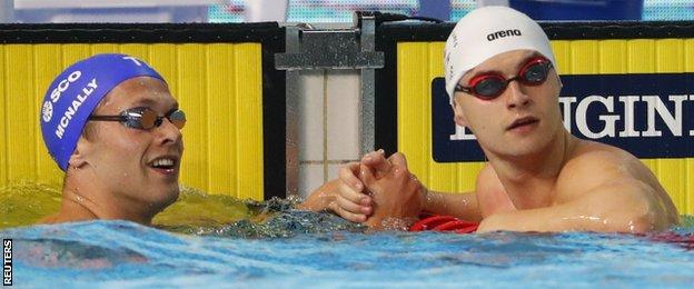 Conor Ferguson shakes hands with Scotland's Craig McNally after their 50m backstroke semi-final on Saturday