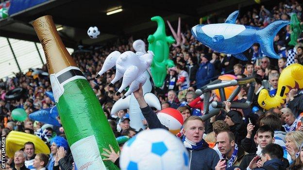 Football fans with inflatables during a match