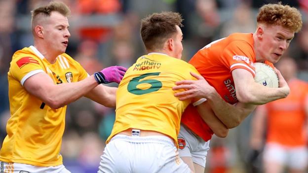 Antrim's Joseph Finnegan and Peter Healy attempt to halt Armagh's man of the match Conor Turbitt