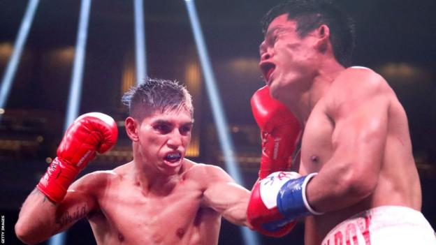 Fernando Martinez connects with a punch on Jerwin Ancajas