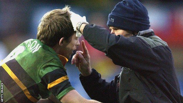 Matt Dawson is checked over by the medic while playing for Northampton