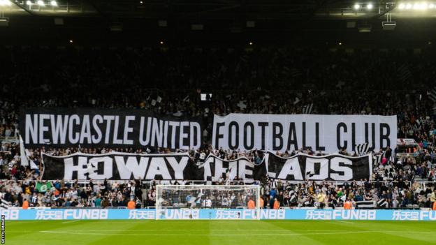 Newcastle United fans display banners during a Premier league fixture