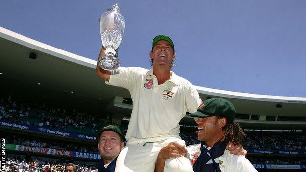 Australia legend Shane Warne (centre) is carried on the shoulders of Michael Clare (left) and Andrew Symonds (right) and holding up the trophy after winning the 2006-07 Ashes against England