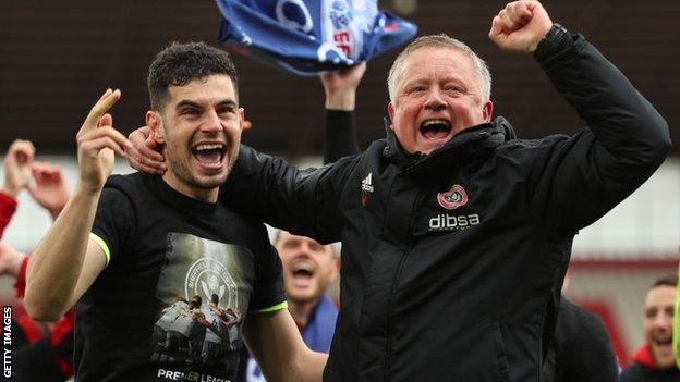 Chris Wilder (right) celebrates promotion to the Premier League with defender John Egan
