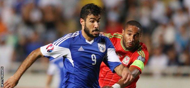 Cyprus' Nestor Mytidis (L) fights for the ball against Wales' Ashley Williams