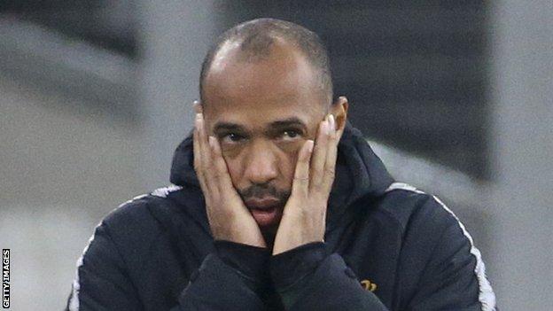 Thierry Henry holds his face after a Monaco defeat