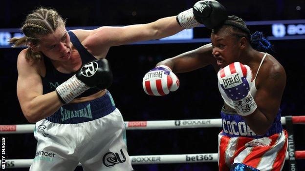 Savannah Marshall aims a punch astatine  Claressa Shields