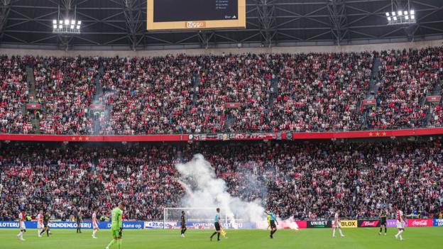 Flares on the pitch during the Ajax v Feyenoord game