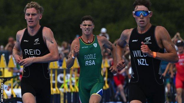Jamie Riddle of South Africa competes alongside New Zealand's Tayler Reid (left) and Hayden Wilde (right) in action in the men's triathlon at the Commonwealth Games in Brimingham