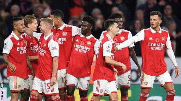 Arsenal players celebrate scoring at Wolves