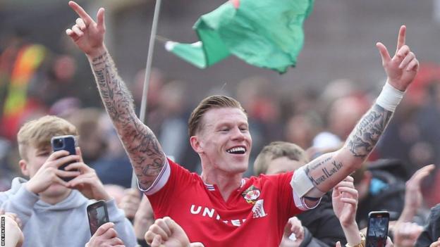 James McClean among Wrexham fans after a pitch invasion at the end of their promotion-clinching win over Forest Green Rovers last weekend