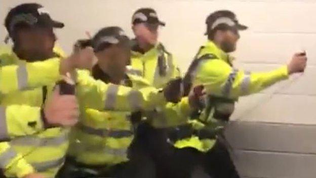 A screengrab of footage appearing to show police using a spray on fans at Deepdale on Saturday