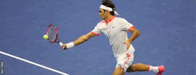 Roger Federer hits a volley