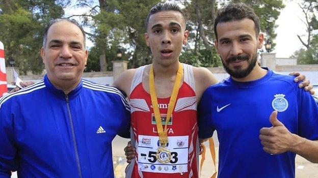 Abu Al-Qasem Rajab (centre) with his bronze medal flanked by his brother Mohammed Rajab (right) and the president of the General Authority for Youth and Sports Bashir Kantari