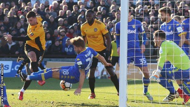 Newport's Padraig Amond has a shot blocked