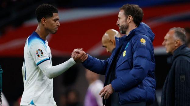 England's Jude Bellingham shakes hands with Gareth Southgate