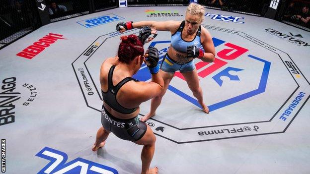 Olena Kolesnyk punches her opponent