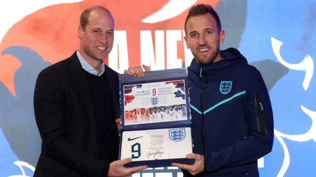 Prince William presents the England players with their shirt numbers the night before their departure