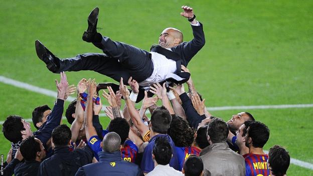 Pep Guardiola is hoisted into the aerial  by Barcelona players and staff