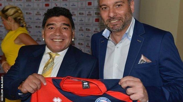 Diego Maradona with Guillem Balague holding up a Biggleswade United shirt
