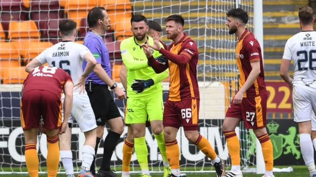 Motherwell's Calum Butcher pleads to referee Alan Muir that it should not be a penalty in the second half.