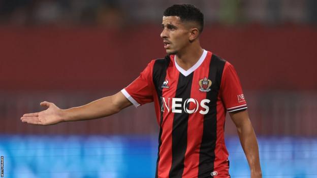 Youcef Atal gestures to a team-mate while playing for Nice