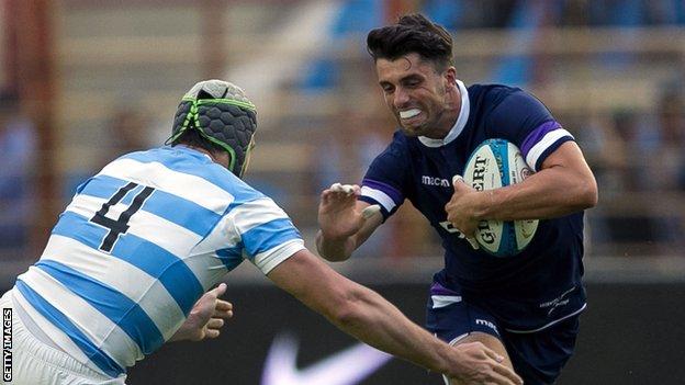 Adam Hastings carries the ball for Scotland against Argentina