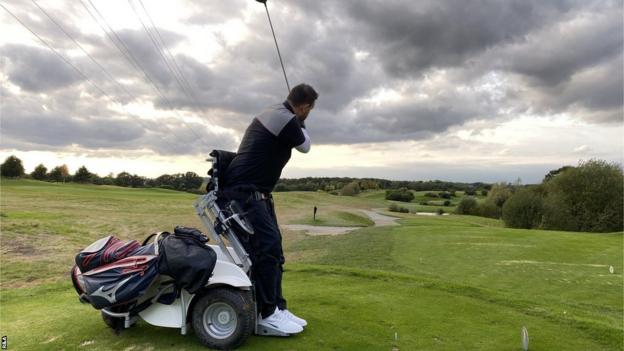 Kris Aves hitting a golf shot with the aid of a ParaGolfer machine