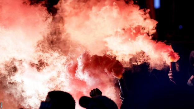 Football supporters let off red flares