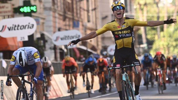 Wout van Aert (right) holds his hands out in celebration after beating Julian Alaphilippe (left) to win the 2020 Milan San-Remo